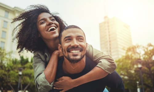 a couple laughing outdoors